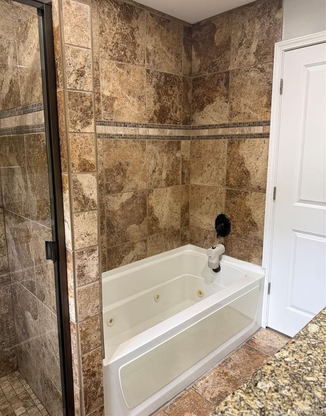 Tub and shower with floor-to-ceiling tile surround