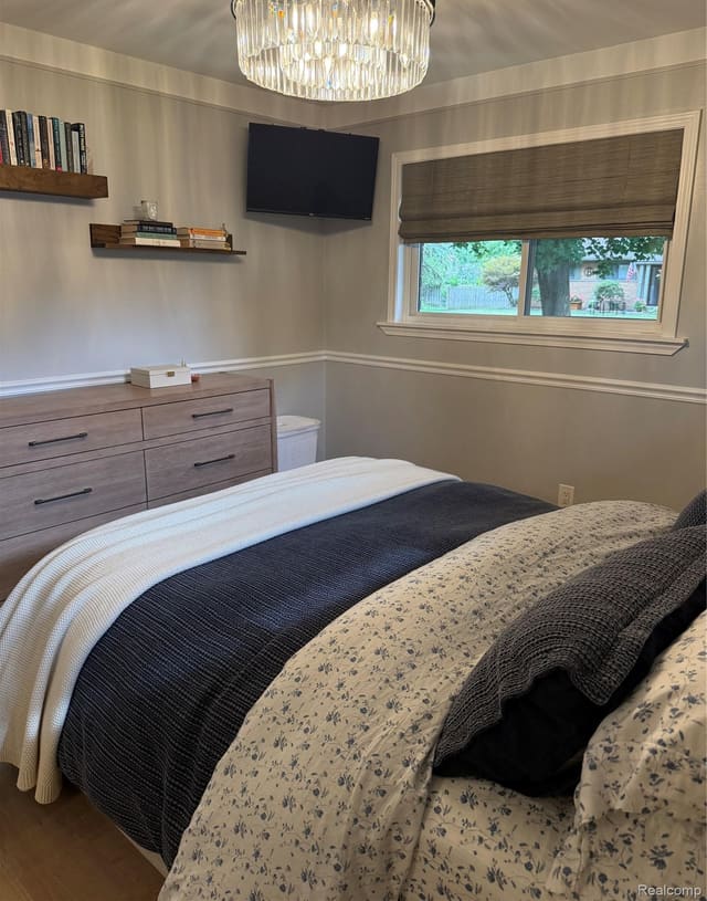 Bedroom with dresser and window light